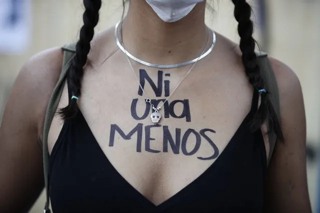 A woman with the words “Not one less” written on her chest in Spanish joins a march to commemorate International Women's Day and protest against gender violence, in Mexico City, Monday, March 8, 2021. (Photo by Rebecca Blackwell/AP Photo)