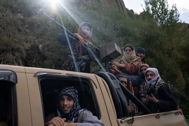 A unit of Taliban fighters ride in a pickup truck on a road in Wardak province, Afghanistan, Sunday, June 18, 2023. (Photo by Rodrigo Abd/AP Photo)