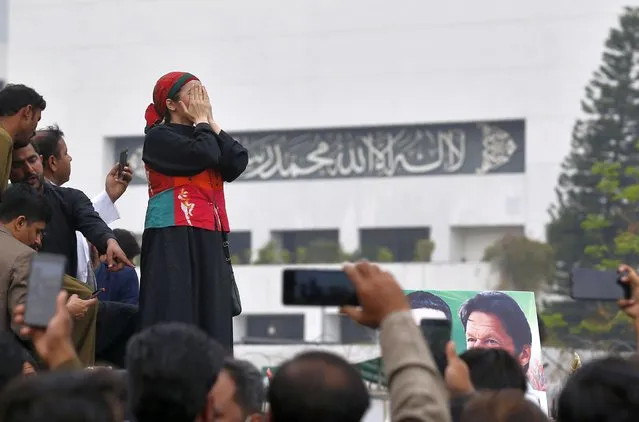 A woman supporter of the ruling Pakistan Tehree-e-Insaf political party prays while along with others gather outside the National Assembly to celebrate Prime Minister Imran Khan winning a vote of confidence in Islamabad, Pakistan, Saturday, March 6, 2021. Khan handily won a vote of confidence from the National Assembly on Saturday, days after the embarrassing defeat of his ruling party's key candidate in Senate elections. (Photo by Anjum Naveed/AP Photo)