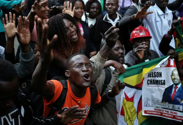 Supporters of the opposition Movement for Democratic Change party (MDC) of Nelson Chamisa, sing and dance in the street outside the party's headquarters following general elections in Harare, Zimbabwe, July 31, 2018. (Photo by Siphiwe Sibeko/Reuters)