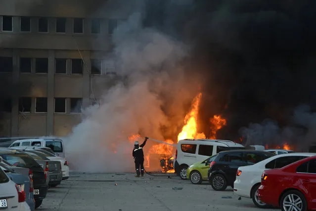 A firefighter tries to extinguish burning vehicles after an explosion outside the governor's office in the southern city of Adana, Turkey, November 24, 2016. (Photo by Ihlas News Agency/Reuters)