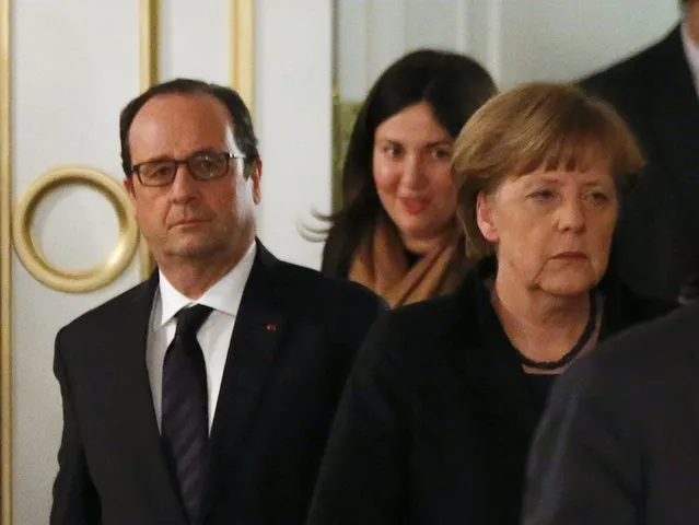 Germany's Chancellor Angela Merkel (R) and France's President Francois Hollande (L) walk as they attend a peace summit to resolve the Ukrainian crisis in Minsk, February 12, 2015. (Photo by Vasily Fedosenko/Reuters)