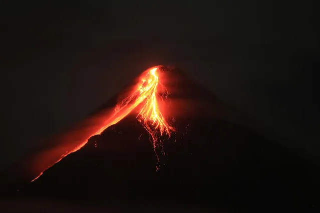 Mount Mayon spews lava during an eruption near Legazpi city in Albay province, south of Manila, Philippines on June 11, 2023. (Photo by Charism Sayat/AFP Photo)