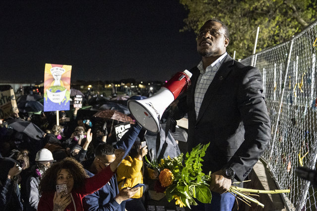 Michael Odiari leads a chant as he attempts to deescalate an altercation between demonstrators and police during a protest decrying the shooting death of Daunte Wright outside the Brooklyn Center Police Department, Friday, April 16, 2021, in Brooklyn Center, Minn. (Photo by John Minchillo/AP Photo)
