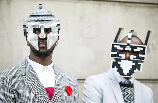 Paul, right, and Peter Allimandi of Bwoy-Wonder, pose for a photo, wearing their self-made LEGO masks, outside the Topman Show Space, at the University of Westminster in London, during the London Collections Men's AW 2016 event, Friday January 8, 2016. (Photo by Lauren Hurley/PA Wire via AP Photo)