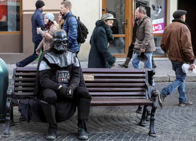 A man dressed as the “Star Wars” character Darth Vader sits on a bench in central Lviv, Ukraine, November 24, 2016. (Photo by Gleb Garanich/Reuters)