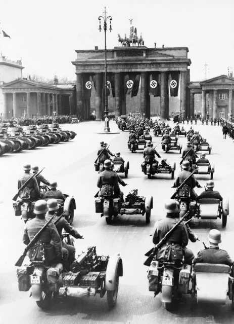 Motorized troops are shown leaving Unter Den Linden as Hitler's birthday parade began several miles farther west on Charlottenburher Chassee, April 26, 1937. Tanks, Machine gun units and motorcycle squads paraded before the chancellor. (Photo by AP Photo)