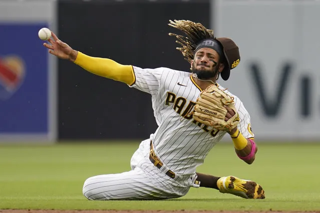 San Diego Padres shortstop Fernando Tatis Jr. throws late to first as Pittsburgh Pirates' Adam Frazier arrives safely for a single during the third inning of a baseball game Wednesday, May 5, 2021, in San Diego. (Photo by Gregory Bull/AP Photo)