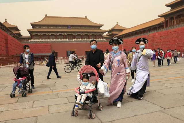 Residents dressed in traditional costumes visit the Forbidden City in Beijing on May 6, 2021. 
China’s population growth is falling closer to zero as fewer couples have children, the government announced Tuesday, May 11, 2021, adding to strains on an aging society with a shrinking workforce. (Photo by Ng Han Guan/AP Photo)