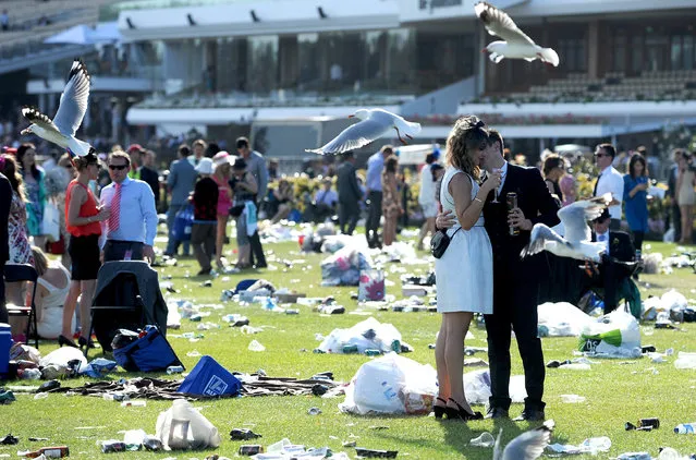 Race goers enjoy the atmosphere at the end of the day at the Melbourne Cup at Flemington Racecourse in Melbourne, Tuesday, November 5, 2013. (Photo by Joe Castro/AAP/Press Association Images)