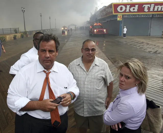 New Jersey Governor Chris Christie (2nd L) tours the fire area with his Deputy Chief of Staff Bridget Anne Kelly (R) and Office of Emergency Management personnel at the boardwalk in Seaside Heights, New Jersey on September 12, 2013 in this handout photo obtained by Reuters on January 9, 2014. New Jersey Governor Chris Christie said at a news conference on January 9, 2014 that he had fired Kelly in the wake of a scandal involving the closure of lanes on the George Washington bridge during a political campaign in September. (Photo by Tim Larsen/Reuters/Governor's Office)