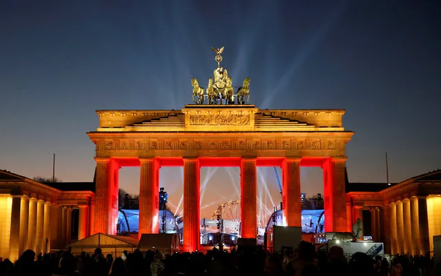 Visitors watch the sound and light check at the Brandenburg Gate, ahead of the upcoming New Year's Eve celebrations in Berlin, Germany, December 30, 2016. (Photo by Fabrizio Bensch/Reuters)