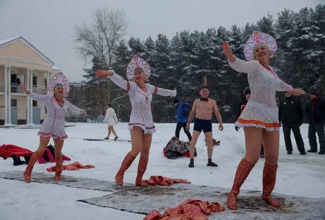Participants wearing Kokoshnik, the Russian traditional headwear, perform during winter swimming festival in the town of Podolsk, south of Moscow, Russia January 5, 2017. (Photo by Maxim Shemetov/Reuters)
