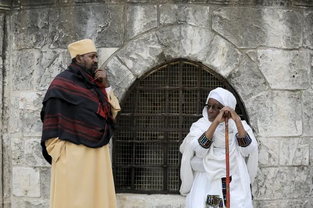 Ethiopian Orthodox worshippers wait for the start of the washing of the feet ceremony outside the Ethiopian section of the Church of the Holy Sepulchre in Jerusalem's Old City April 9, 2015, ahead of Orthodox Easter. (Photo by Ammar Awad/Reuters)