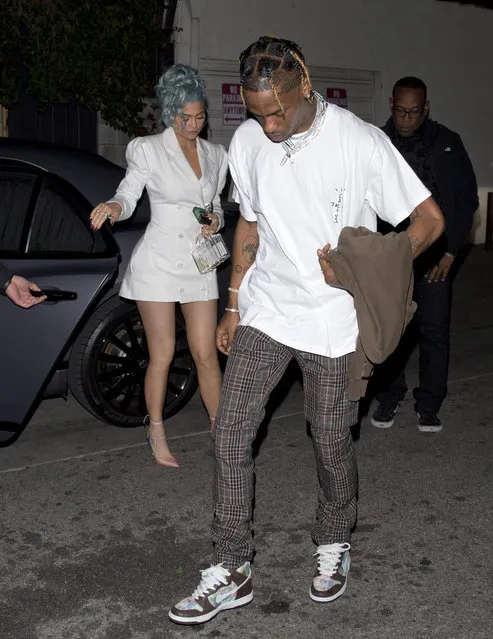 Kylie Jenner wears a beautiful white suit with a short mini skirt and carries a clear designer purse while carrying a disposable camera as she and her singer Boyfriend Travis Scott head to dinner on New Years Eve at “Craigs” in West Hollywood, CA on January 1, 2019. (Photo by SPW/Splash News and Pictures)