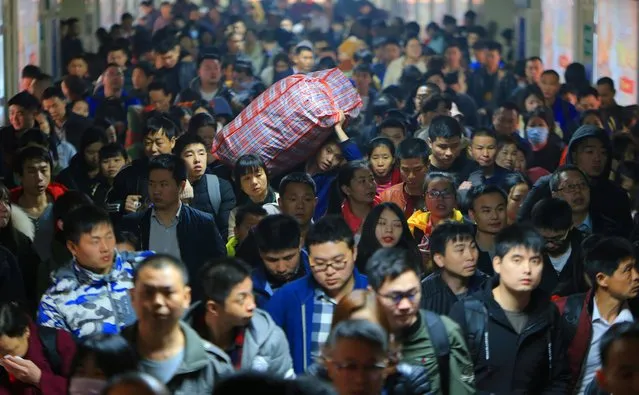 Train passengers travelling during the Spring Festival travel rush ahead of Chinese Lunar New Year arrive at the Hengyang Railway Station in Hunan province, January 30, 2019. Hundreds of millions of Chinese are on the move ahead of the Lunar New Year holiday. (Photo by Reuters/China Stringer Network)