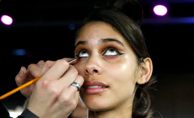 A model has her makeup done for the Maybelline New York show ahead of the Berlin Fashion Week Autumn/Winter 2017 in Berlin, Germany, January 16, 2017. (Photo by Fabrizio Bensch/Reuters)
