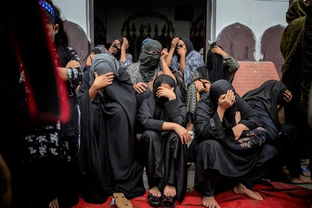 Shiite Muslims cry as they listen to a cleric narrating the battle of Karbala during Ashoura procession in New Delhi, India, Friday, August 20, 2021. Ashoura falls on the 10th day of Muharram, the first month of the Islamic calendar, when Shiites mark the death of Hussein, the grandson of the Prophet Muhammad, at the Battle of Karbala in present-day Iraq in the 7th century. (Photo by Altaf Qadri/AP Photo)