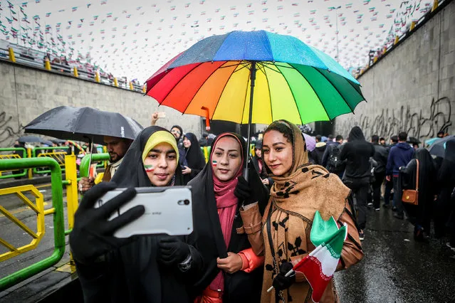 An Iranian woman take selfies during a ceremony to mark the 40th anniversary of the Islamic Revolution in Tehran, Iran on February 11, 2019. (Photo by Vahid Ahmadi/Tasnim News Agency via Reuters)