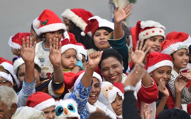 Members of the Pakistani Christian minority parade ahead of Christmas on a road in Karachi, Pakistan, 17 December 2023. Around the world, billions of people annually celebrate Christmas on 25 December to commemorate the birth of Jesus Christ. (Photo by Shahzaib Akber/EPA/EFE)