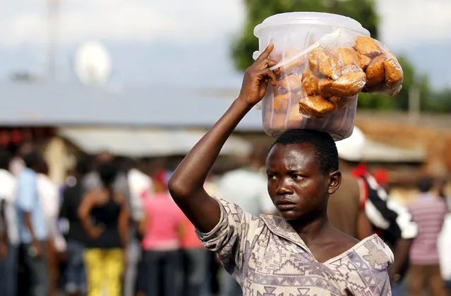 A vendor sells doughnuts during protests against the decision made by Burundi's ruling National Council for the Defence of Democracy-Forces for the Defence of Democracy (CNDD-FDD) party to allow President Pierre Nkurunziza to run for a third five-year term in office, in the capital Bujumbura, April 26, 2015. (Photo by Thomas Mukoya/Reuters)