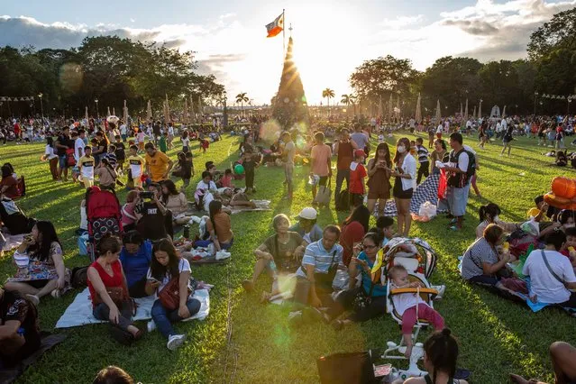 People gather at Rizal Park on Christmas day in Manila on December 25, 2023. (Photo by Earvin Perias/AFP Photo)
