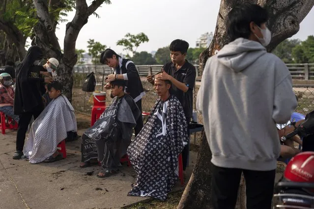 Residents get free haircuts from trainee stylists in Ho Chi Minh City, Vietnam, January 14, 2024. (Photo by Jae C. Hong/AP Photo)