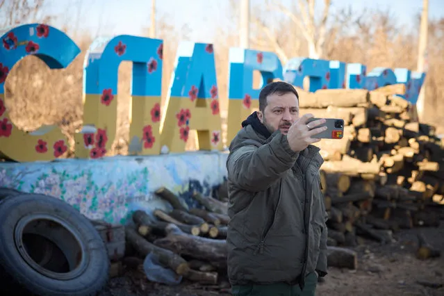 This handout picture taken and released by the Ukrainian Presidential press service on December 6, 2022, shows Ukrainian President Volodymyr Zelensky recording his address to Ukrainians in front of the sign of the town of Sloviansk during his visit in the Donetsk region, amid the Russian invasion of Ukraine. President Volodymyr Zelensky on December 6, 2022 visited the frontline region of Donetsk in east Ukraine, describing fighting in the area as “difficult” with Russian forces pushing to capture the industrial city of Bakhmut. (Photo by Handout/Ukrainian Presidential Press Service/AFP Photo)