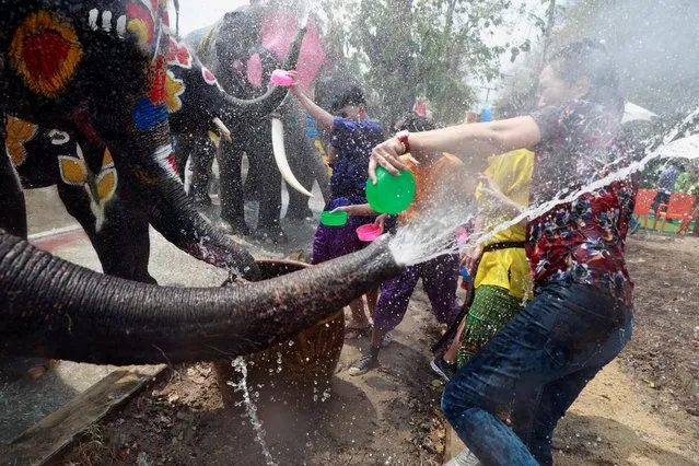 Elephants and people play with water as part of celebrations for the water festival of Songkran, which marks the start of the Thai New Year in Ayutthaya, Thailand on April 11, 2019. (Photo by Soe Zeya Tun/Reuters)