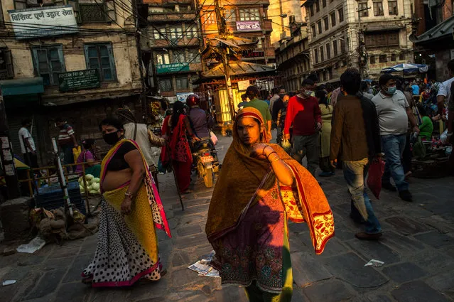 People walk on the street on May 4, 2015 in Kathmandu, Nepal. A major 7.9 earthquake hit Kathmandu mid-day on Saturday April 25th, and was followed by multiple aftershocks that triggered avalanches on Mt. Everest that buried mountain climbers in their base camps. (Photo by David Ramos/Getty Images)