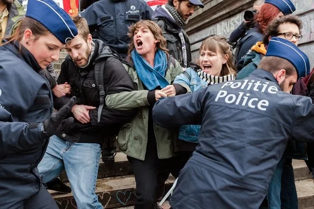 Police detain a group of people at the Place de la Bourse in Brussels, Belgium, Saturday, April 2, 2016. Authorities had banned all marches in Brussels, after a far-right group announced its plans to hold an anti-Muslim rally in the city. (Photo by Geert Vanden Wijngaert/AP Photo)