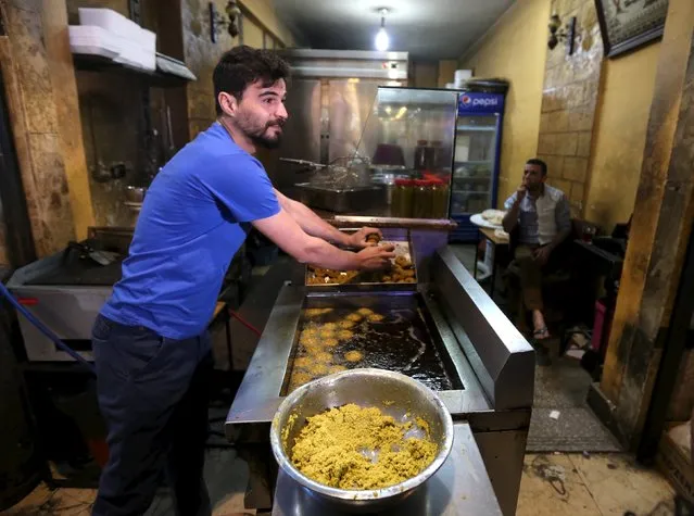 Syrians work at a Syrian restaurant in an area called 6 October City in Giza, Egypt, March 19, 2016. (Photo by Mohamed Abd El Ghany/Reuters)