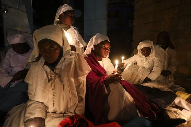 Kenyan Legio Maria believers attend the Easter vigil mass at the St. Joanes, Legio Maria of African Church Mission in Kibera slums, in Nairobi, Kenya, 30 March 2024. Christians commemorate the crucifixion of Jesus Christ. (Photo by Daniel Irungu/EPA)