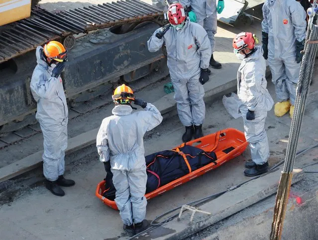 Crew members recover a body from The Mermaid, a Hungarian boat which sank in the Danube river near Margaret bridge, during a salvage operation in Budapest, Hungary June 11, 2019. (Photo by Marko Djurica/Reuters)