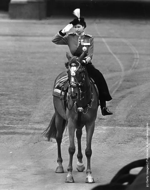 1952: Queen Elizabeth II riding a horse side saddle and saluting during a Trooping of the Colour ceremony at Horse Guard's Parade, Central London