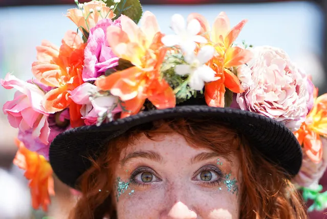 A woman with an elaborate hat poses during Glastonbury Festival at Worthy farm in Somerset, Britain on June 27, 2019. (Photo by Henry Nicholls/Reuters)