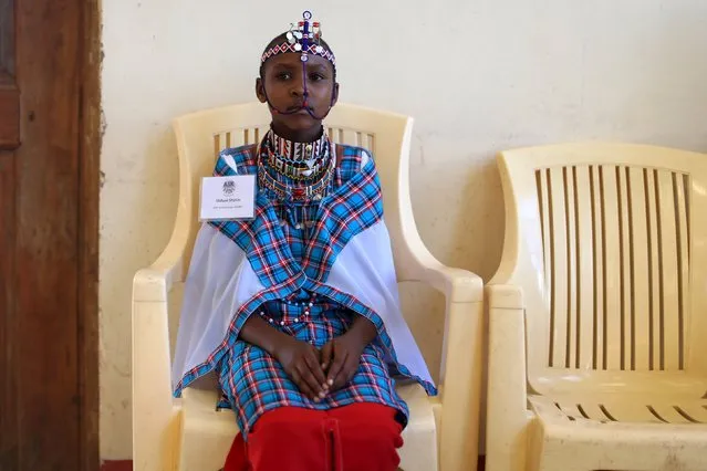 A Maasai girl waits for the start of a social event advocating against harmful practices such as Female Genital Mutilation (FGM) at the Imbirikani Girls High School in Imbirikani, Kenya, April 21, 2016. (Photo by Siegfried Modola/Reuters)