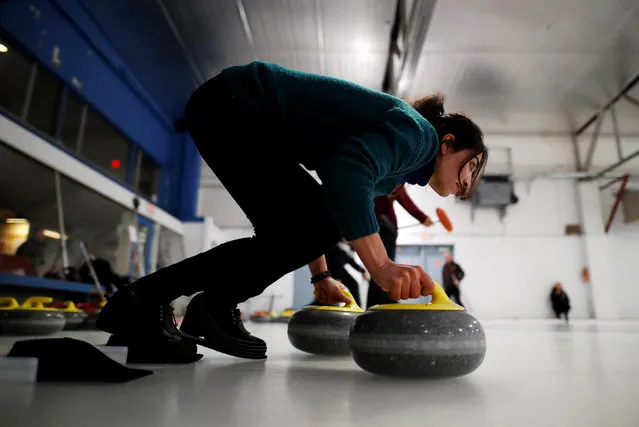 A Yazidi refugee from Kurdistan learns the sport of curling at the Royal Canadian Curling Club during an event put on by the “Together Project”, in Toronto, March 15, 2017. (Photo by Mark Blinch/Reuters)