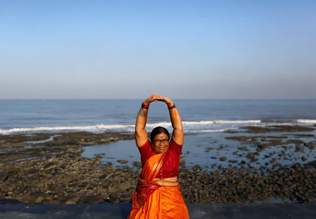 Wearing a saree, traditional women's cloth, a woman exercises on a promenade along the Arabian Sea in Mumbai, India, March 20, 2017. (Photo by Danish Siddiqui/Reuters)