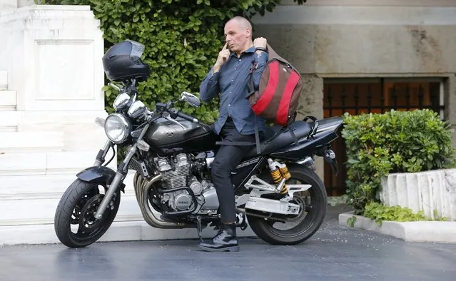 Greek Finance Minister Yanis Varoufakis arrives on his motorbike prior to a meeting at the office of Prime Minister Alexis Tsipras in Maximos Mansion in Athens, Greece, July 1, 2015. Prime Minister Alexis Tsipras called on Greeks to vote “no” in Sunday's referendum on a bailout package offered by creditors, in a defiant address that dispelled speculation he was rowing back on the plan under mounting pressure. (Photo by Jean-Paul Pelissier/Reuters)