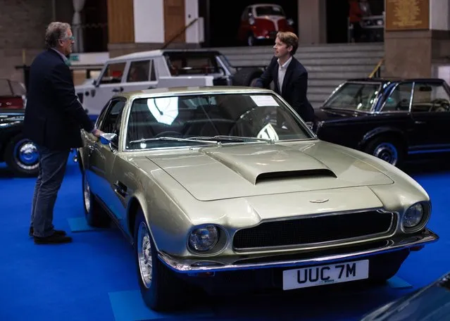 Two men inspect a 1973 Aston Martin V8 (estimate £75,000 - £90,000) inside the Royal Horticultural Halls on April 11, 2017 in London, England. (Photo by Jack Taylor/Getty Images)