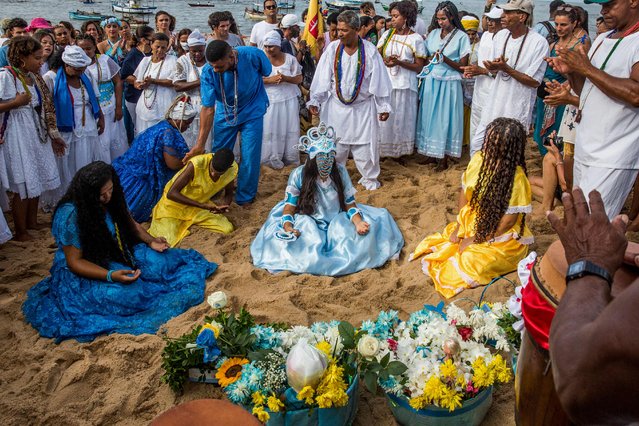 Worshippers take part in the traditional ceremony of Iemanja, the Goddess of the Sea of the syncretic Afro-Brazilian religion Umbanda at the Rio Vermelho neighborhood, in Salvador, Bahia, Brazil on February 2, 2023. (Photo by Antonello Veneri/AFP Photo)