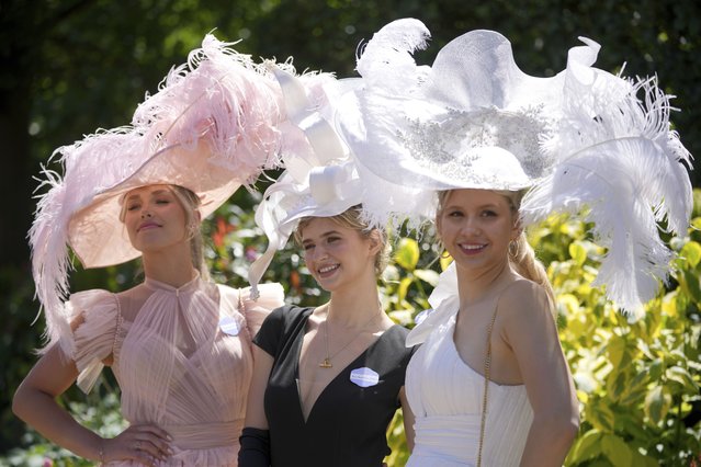 Emily Bowen, left with Anastasia Tutus and Maria Tutus pose for the photographers, wearing ornate hats on the third day of the Royal Ascot, horse race meeting, traditional known as Ladies Day, at Ascot, England, Thursday, June 20, 2024. (Photo by Kin Cheung/AP Photo)