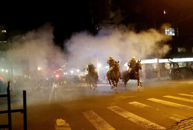 Policemen ride their horses during a clash with demonstrators at a protest against the impeachment of President Dilma Rousseff, in Porto Alegre, Brazil, May 12, 2016Lunae Parracho