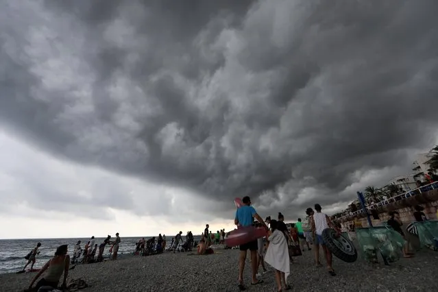 People leave the beach as a storm approaches in Nice, France on August 12, 2019. (Photo by Eric Gaillard/Reuters)