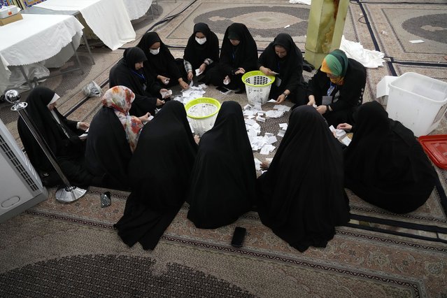 Election officials count presidential election ballots at a polling station in Tehran, Iran, July 6, 2024. (Photo by Vahid Salemi/AP Photo)