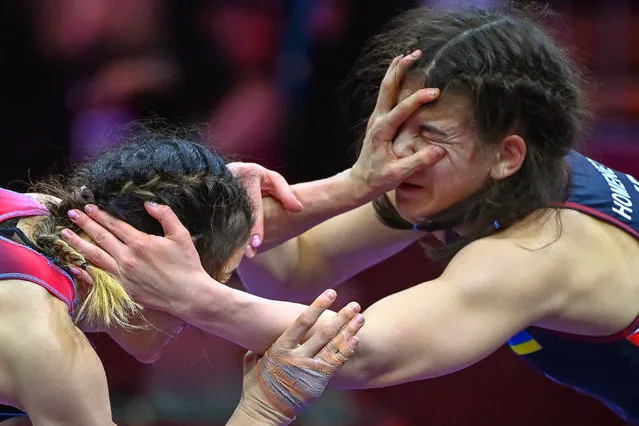Bediha Gun (L) of Turkey in action against Oleksandra Khomenets (R) of Ukraine during their semi final bout of the women's Freestyle 55kg category at the European Wrestling Championships in Budapest, Hungary, 30 March 2022. (Photo by Tibor Illyes/EPA/EFE)