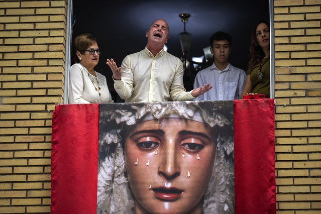 Worshipper Jose Maria Segura signs a “saeta” as the Virgin Mary is carried out of the church during the procession of “El Cerro” brotherhood in Seville, Spain, Tuesday, April 4, 2023. Hundreds of processions take place throughout Spain during the Easter Holy Week. (Photo by Emilio Morenatti/AP Photo)