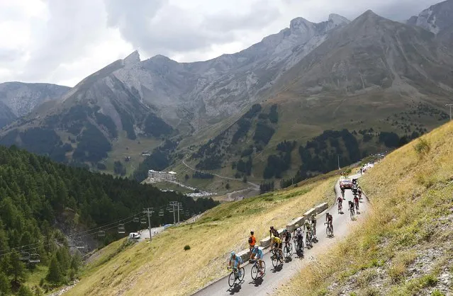 Team Sky rider Chris Froome of Britain (3rdL), the race leader's yellow jersey, climbs with a group of riders during the 161-km (100 miles) 17th stage of the 102nd Tour de France cycling race from Digne-les-Bains to Pra Loup in the French Alps mountains, France, July 22, 2015. (Photo by Stefano Rellandini/Reuters)