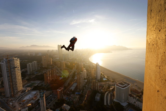 A base jumper in action during the BASE Jump Extreme World Championship at Gran Hotel Bali in Benidorm, Spain, 27 April 2023. The championship gathers more than 20 jumpers from different nationalities to jump from one of the tallest hotels in Europe. (Photo by Manuel Lorenzo/EPA)